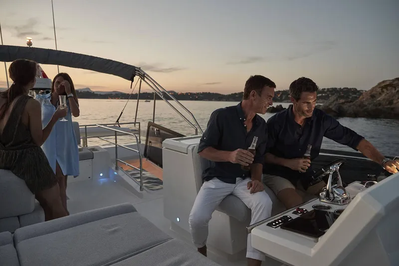  Yacht Photos Pics Manufacturer Provided Image: People enjoying sunset on a 2024 Prestige 590 yacht, holding drinks.