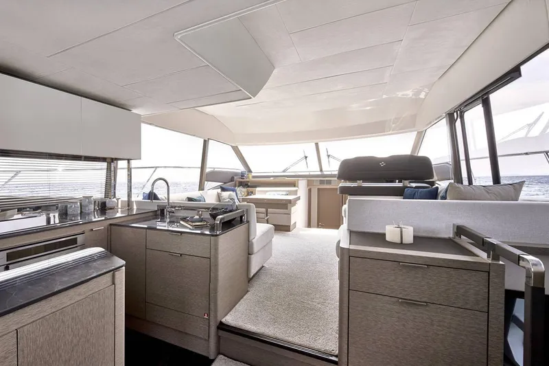  Yacht Photos Pics Manufacturer Provided Image: Luxurious interior of 2024 Prestige 590 yacht with modern kitchen and seating area.
