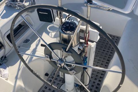 Steering wheel of a 1985 Pearson 36-2 sailboat with navigation instruments.