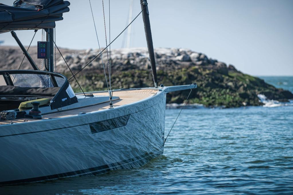 Saffier SE 33 Life 2026 sailboat on calm waters near rocky shoreline.
