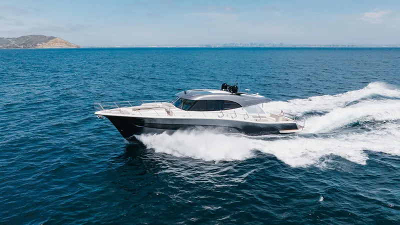 Hermosa Yacht Photos Pics 2022 Riviera 645 SUV yacht cruising on open sea under clear blue sky.