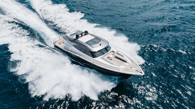 Hermosa Yacht Photos Pics Luxury 2022 Riviera 645 SUV yacht cruising on open ocean waters.
