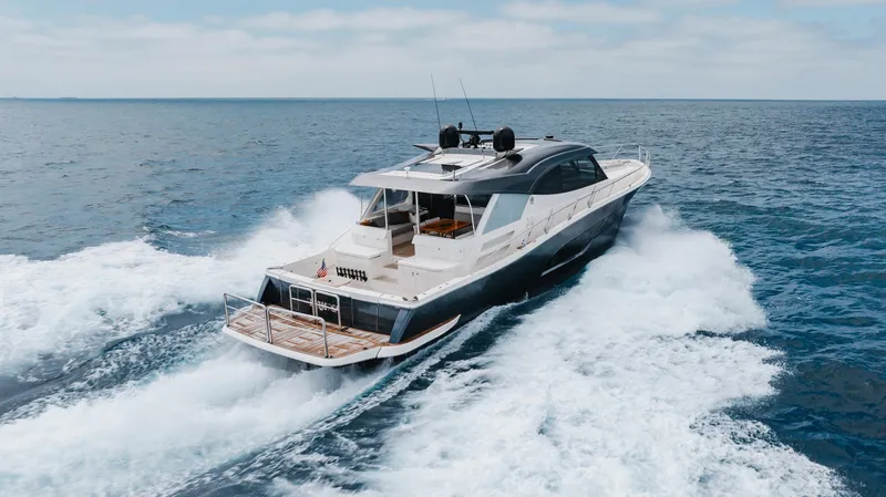 Hermosa Yacht Photos Pics 2022 Riviera 645 SUV yacht cruising on open sea, showcasing luxury and performance.