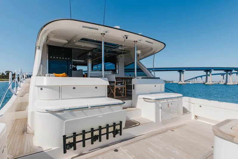 Hermosa Yacht Photos Pics 2022 Riviera 645 SUV yacht with spacious deck, modern design, and ocean backdrop.