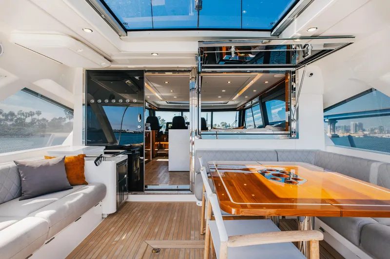 Hermosa Yacht Photos Pics Luxurious interior of 2022 Riviera 645 SUV yacht with elegant seating and dining area.