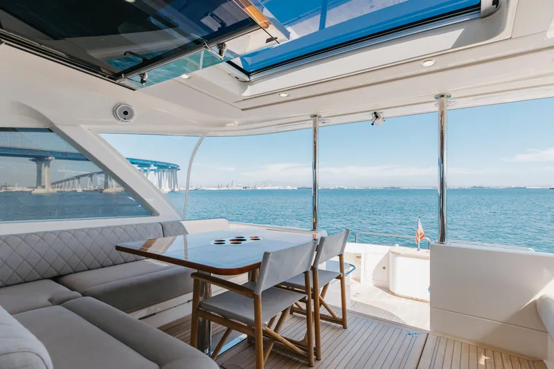 Hermosa Yacht Photos Pics Luxurious 2022 Riviera 645 SUV yacht interior with ocean view and elegant seating area.