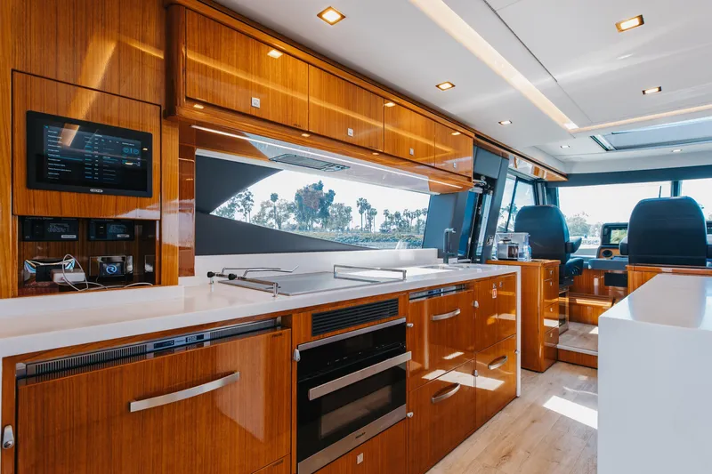 Hermosa Yacht Photos Pics Luxurious interior of 2022 Riviera 645 SUV yacht with modern kitchen amenities.