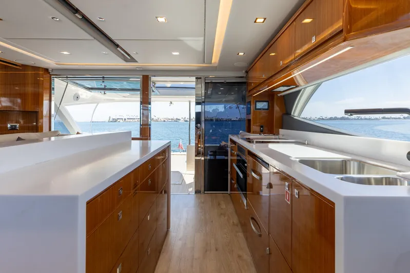 Hermosa Yacht Photos Pics Luxurious interior of 2022 Riviera 645 SUV yacht with modern kitchen and ocean view.