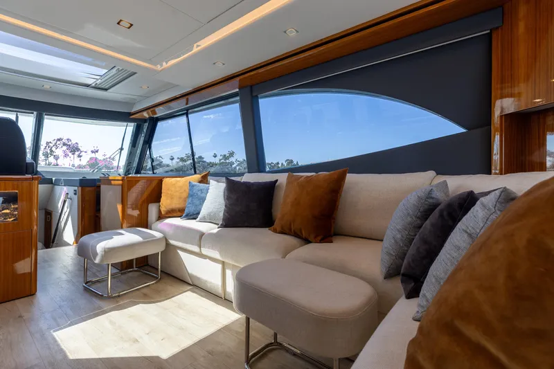 Hermosa Yacht Photos Pics Luxurious interior of 2022 Riviera 645 SUV yacht with plush seating and panoramic windows.