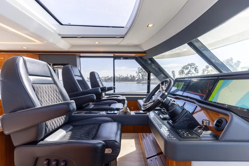 Hermosa Yacht Photos Pics Luxurious interior of 2022 Riviera 645 SUV yacht with leather seating and modern helm.