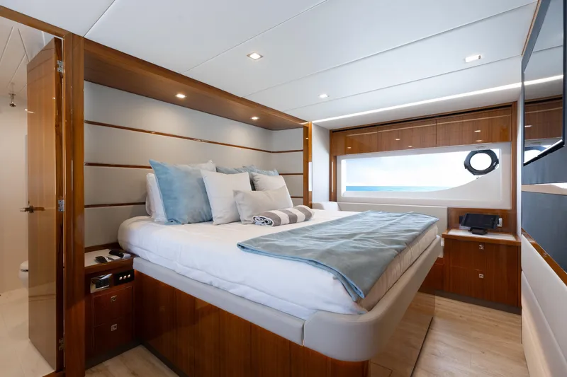 Hermosa Yacht Photos Pics Luxurious bedroom interior of 2022 Riviera 645 SUV yacht with modern design and ocean view.
