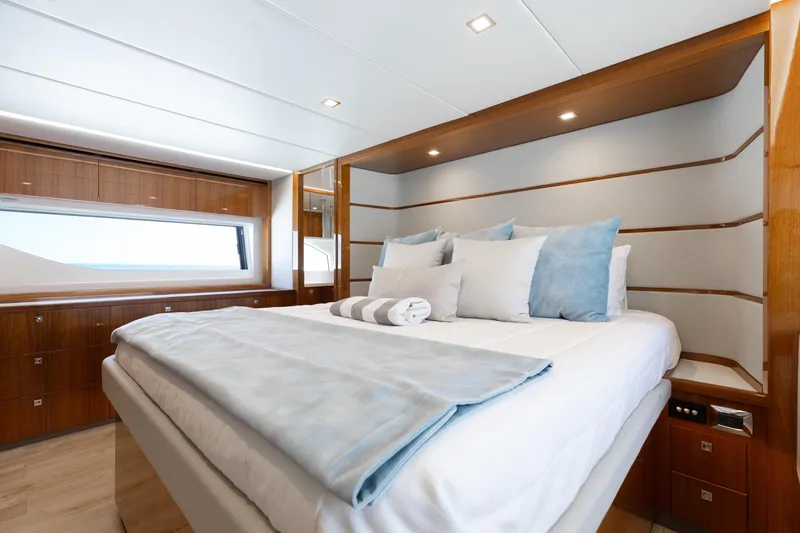 Hermosa Yacht Photos Pics Luxurious bedroom interior of 2022 Riviera 645 SUV yacht with modern design and cozy bedding.