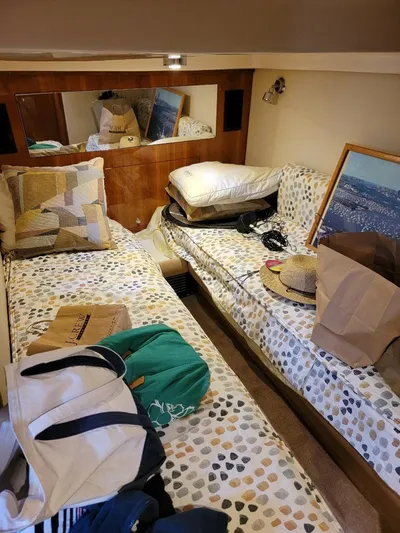 Dorado Yacht Photos Pics Interior cabin of 2007 Regal Commodore 4460 with twin beds and scattered belongings.