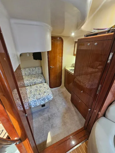 Dorado Yacht Photos Pics Interior cabin of a 2007 Regal Commodore 4460 yacht with bed and wooden cabinetry.