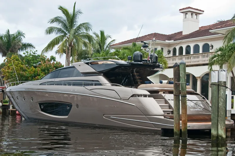 Da Rose Yacht Photos Pics Luxurious 2012 Riva 86' DOMINO yacht docked near a waterfront mansion.