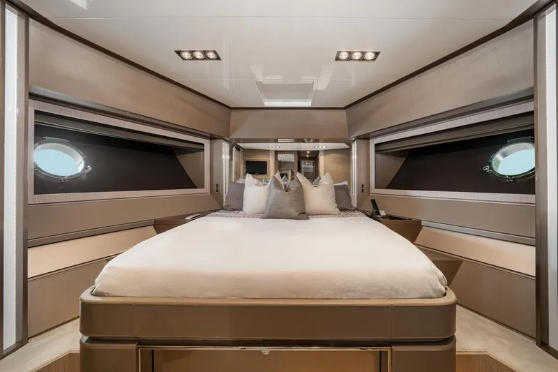 Da Rose Yacht Photos Pics Luxurious bedroom interior of 2012 Riva 86' DOMINO yacht with modern design and porthole windows.