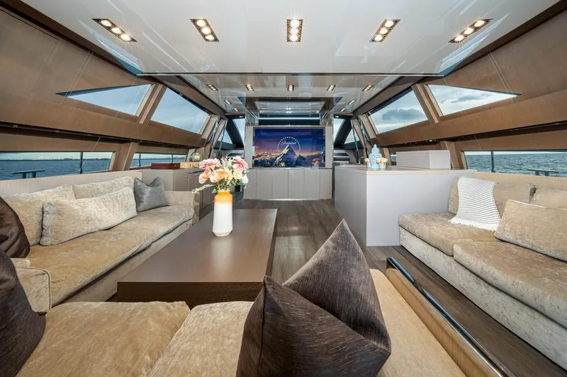 Da Rose Yacht Photos Pics Luxurious interior of 2012 Riva 86' DOMINO yacht with elegant seating and panoramic windows.