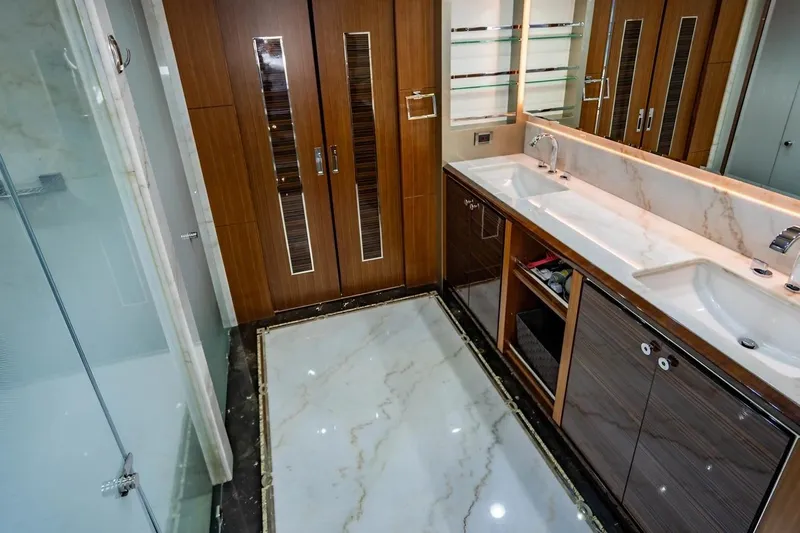 Bella Lisa Yacht Photos Pics Luxurious bathroom in 2020 Ocean Alexander 100 Skylounge Megayacht with dual sinks and elegant wood finishes.