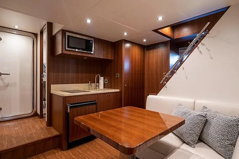 Bella Lisa Yacht Photos Pics Luxurious interior of 2020 Ocean Alexander 100 Skylounge Megayacht with modern kitchenette and seating area.