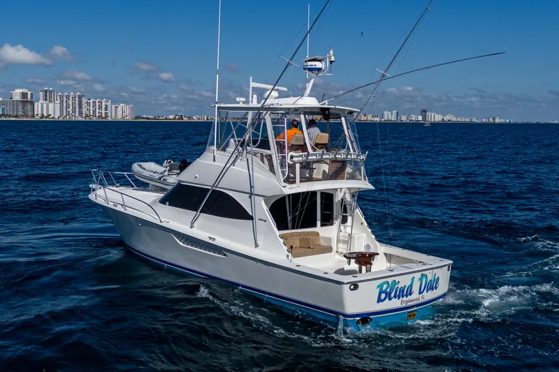 Blind Date Yacht Photos Pics 2016 Viking 46 Convertible yacht cruising on open water, city skyline in background.
