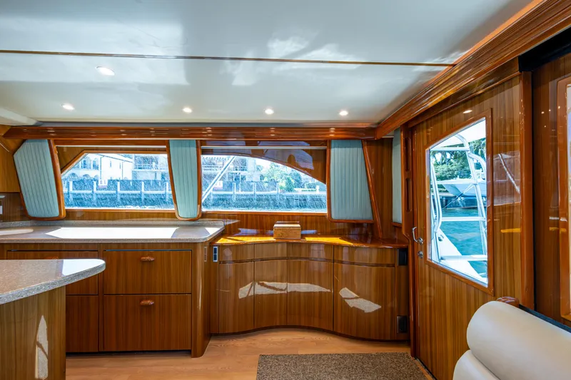 Blind Date Yacht Photos Pics Interior of 2016 Viking 46 Convertible yacht with polished wood finish and large windows.