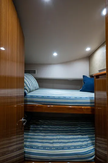 Blind Date Yacht Photos Pics Interior cabin of 2016 Viking 46 Convertible yacht with striped bedding.