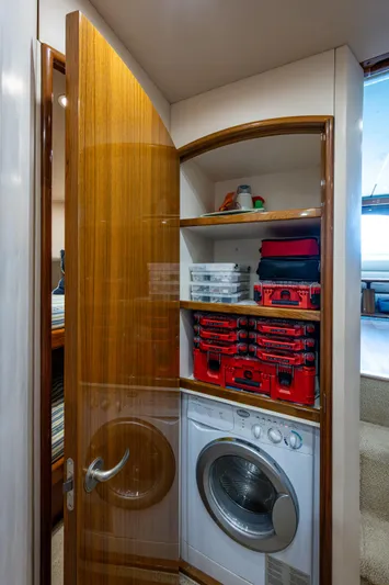 Blind Date Yacht Photos Pics Laundry area in 2016 Viking 46 Convertible yacht with storage shelves.