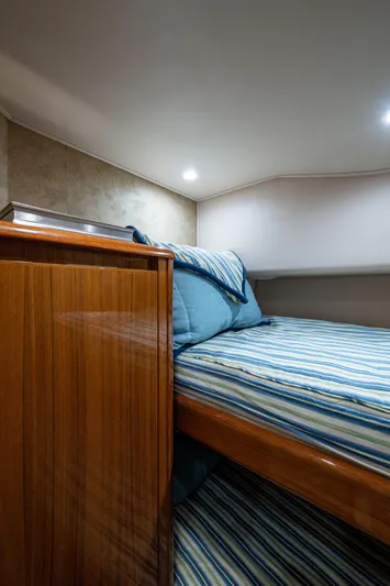 Blind Date Yacht Photos Pics Cozy cabin interior of 2016 Viking 46 Convertible yacht with striped bedding.