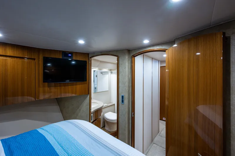 Blind Date Yacht Photos Pics Interior of 2016 Viking 46 Convertible yacht with modern wood finish and cozy bedroom.