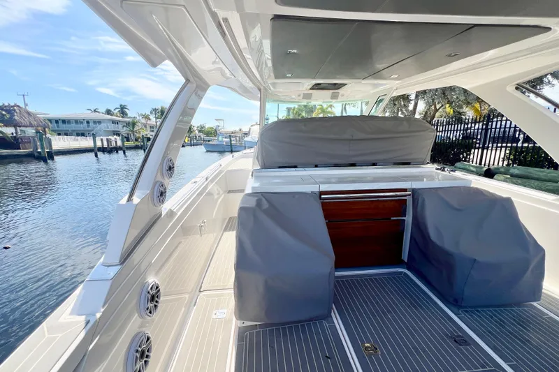  Yacht Photos Pics 2019 Tiara Sport 38 LS boat interior with covered seating and waterfront view.