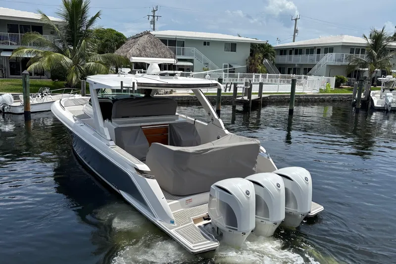  Yacht Photos Pics 2019 Tiara Sport 38 LS boat docked in a marina with triple outboard engines.
