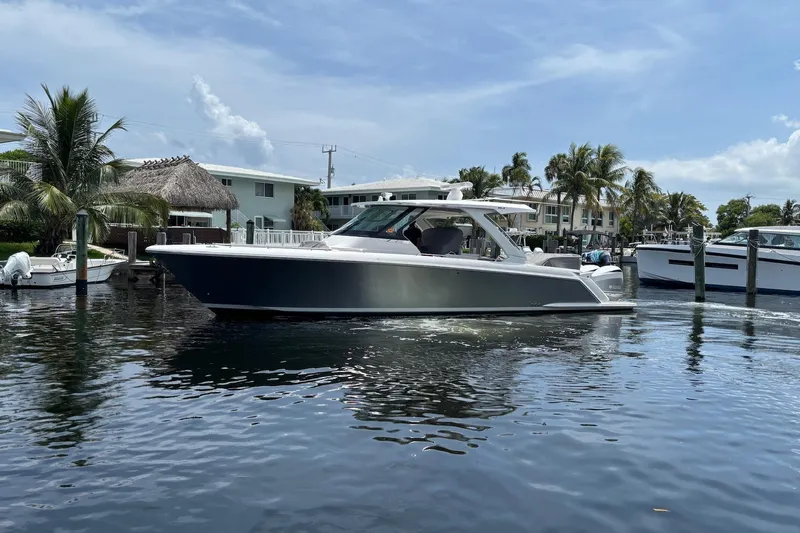  Yacht Photos Pics 2019 Tiara Sport 38 LS boat docked in a sunny marina setting.