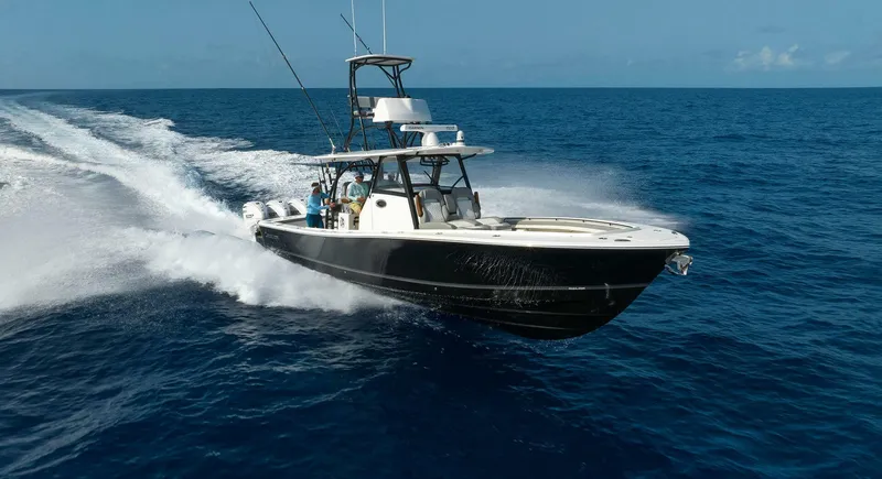  Yacht Photos Pics 2025 Regulator 41 CC boat cruising on open ocean waters.