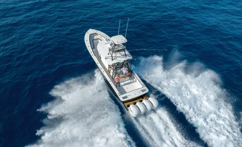  Yacht Photos Pics 2025 Regulator 41 CC boat cruising on open blue ocean waters.