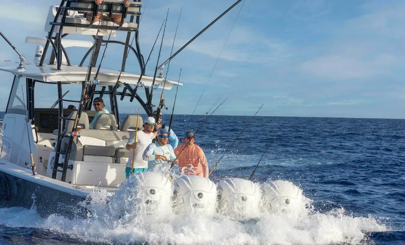  Yacht Photos Pics 2025 Regulator 41 CC boat with anglers on open ocean, featuring multiple outboard engines.