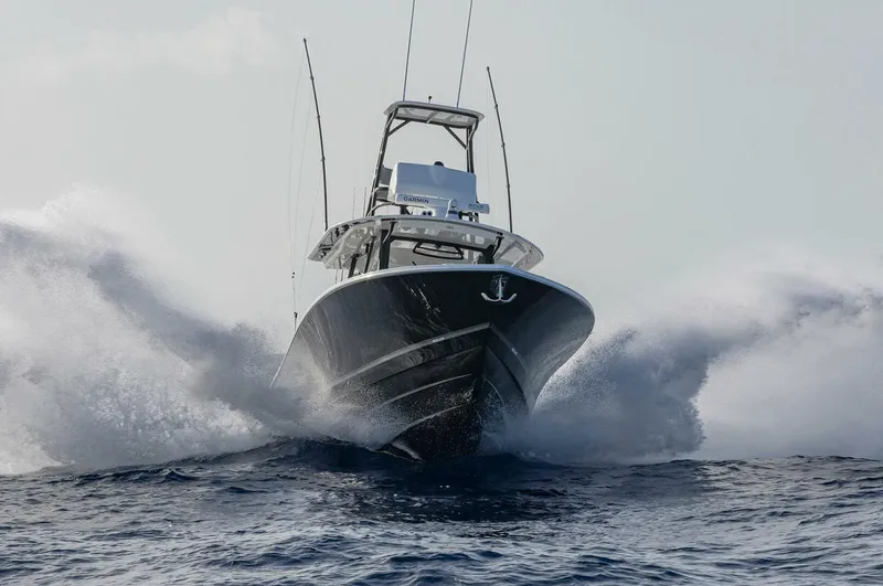  Yacht Photos Pics 2025 Regulator 41 CC boat cutting through ocean waves.