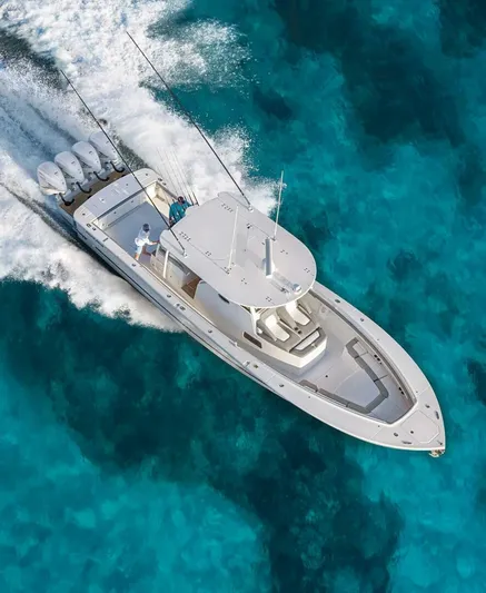  Yacht Photos Pics 2025 Regulator 41 CC boat cruising on clear turquoise water.