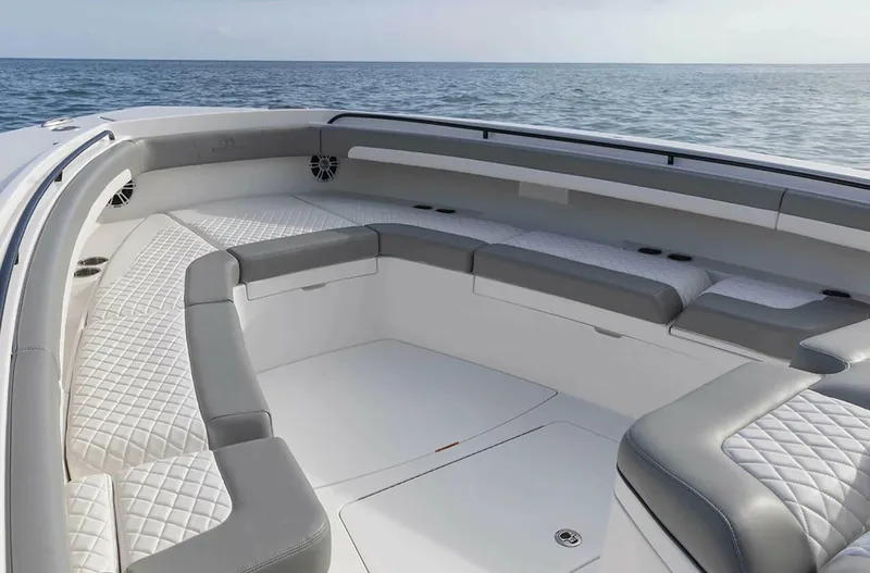  Yacht Photos Pics Luxurious seating on 2025 Regulator 41 CC boat, featuring elegant design and ocean backdrop.