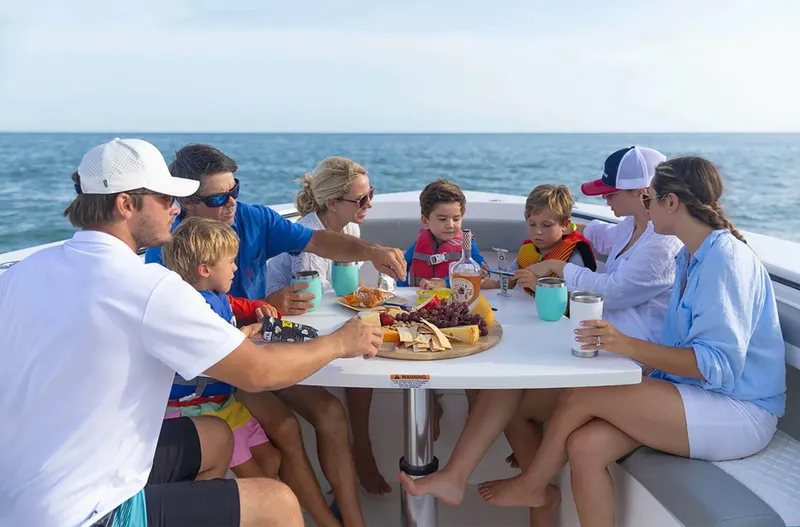 Yacht Photos Pics Family enjoying a meal on a 2025 Regulator 41 CC boat at sea.