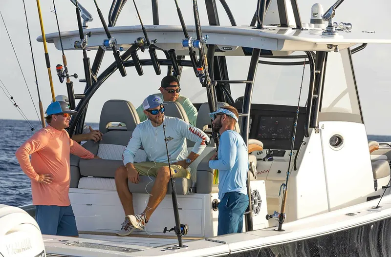  Yacht Photos Pics Four people on a 2025 Regulator 41 CC boat, enjoying a fishing trip.