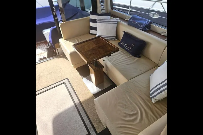 Sea Czar Yacht Photos Pics Interior of 2015 Fairline Targa 48 GT yacht with beige seating and decorative pillows.