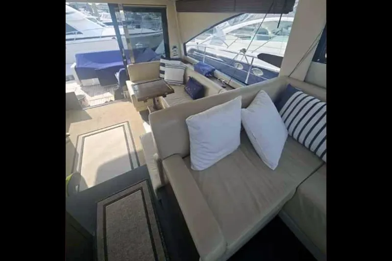 Sea Czar Yacht Photos Pics Interior of 2015 Fairline Targa 48 GT yacht with beige seating and striped cushions.