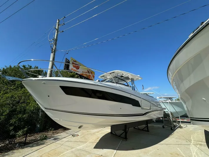  Yacht Photos Pics 2024 Jeanneau 10.5 WALK boat displayed outdoors under clear blue sky.