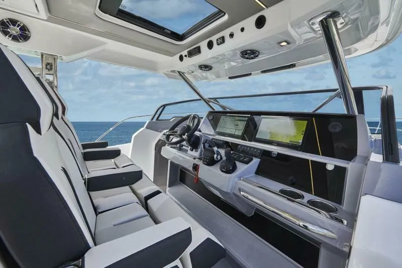 Yacht Photos Pics 2024 Jeanneau 10.5 WALK boat interior with modern dashboard and ocean view.