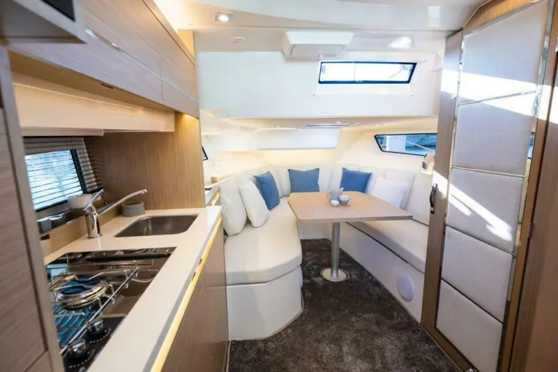  Yacht Photos Pics 2024 Jeanneau 10.5 WALK interior with modern kitchen and cozy dining area.