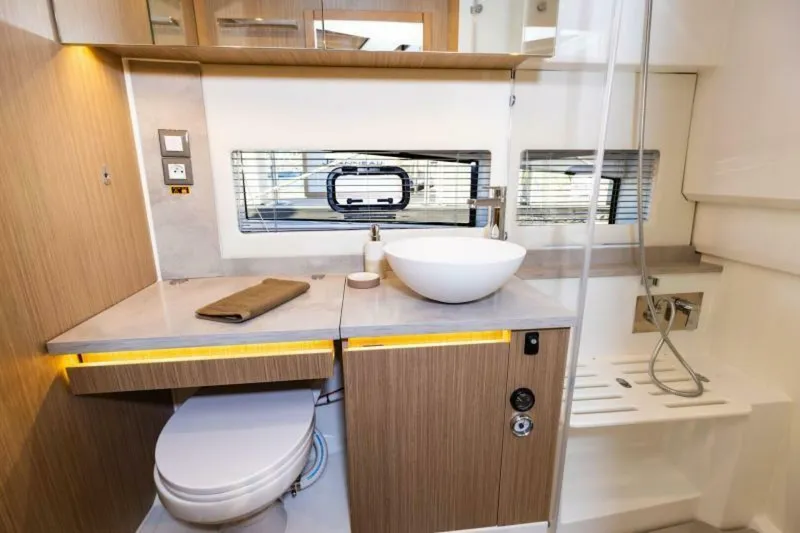  Yacht Photos Pics 2024 Jeanneau 10.5 WALK bathroom with modern sink, toilet, and shower.
