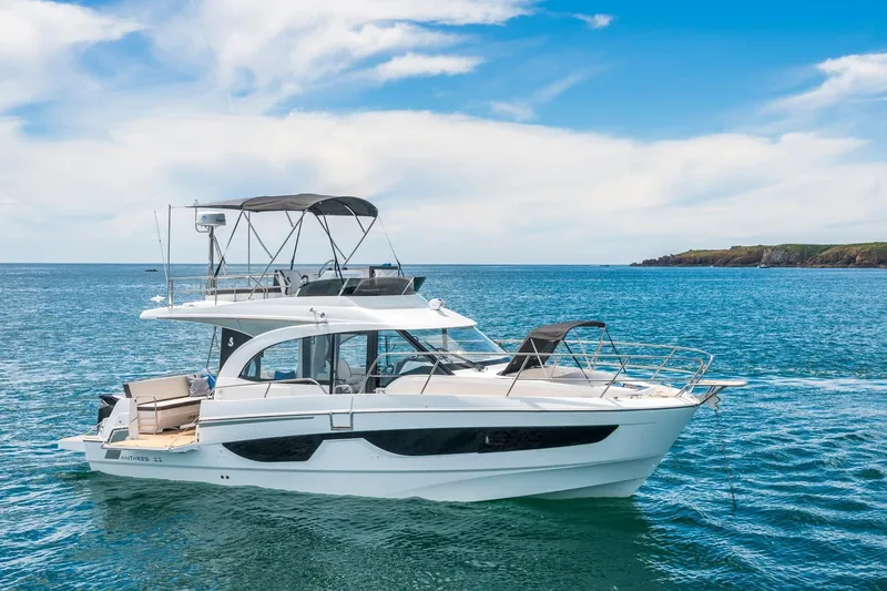  Yacht Photos Pics 2026 Beneteau Antares 11 yacht cruising on a serene ocean with clear skies.