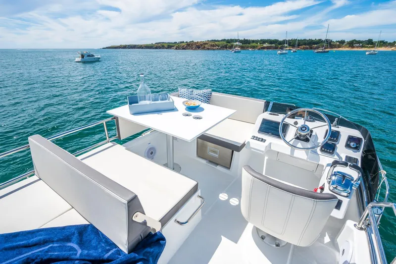  Yacht Photos Pics 2026 Beneteau Antares 11 boat interior with helm, seating, and ocean view.