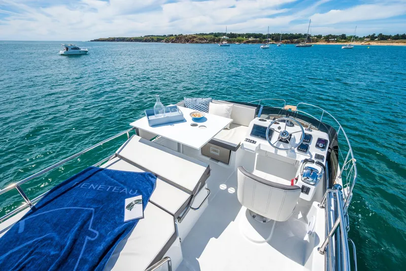  Yacht Photos Pics 2026 Beneteau Antares 11 yacht interior with helm, seating, and ocean view.