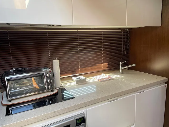 Sea Czar Yacht Photos Pics Modern kitchen area in a 2015 Fairline Targa 48 GT yacht with appliances and sleek design.